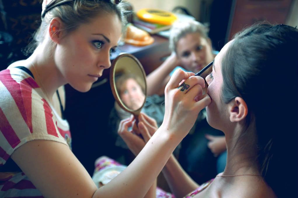 applying makeup to the bride