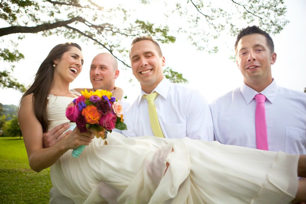 bride being held by groomsmen