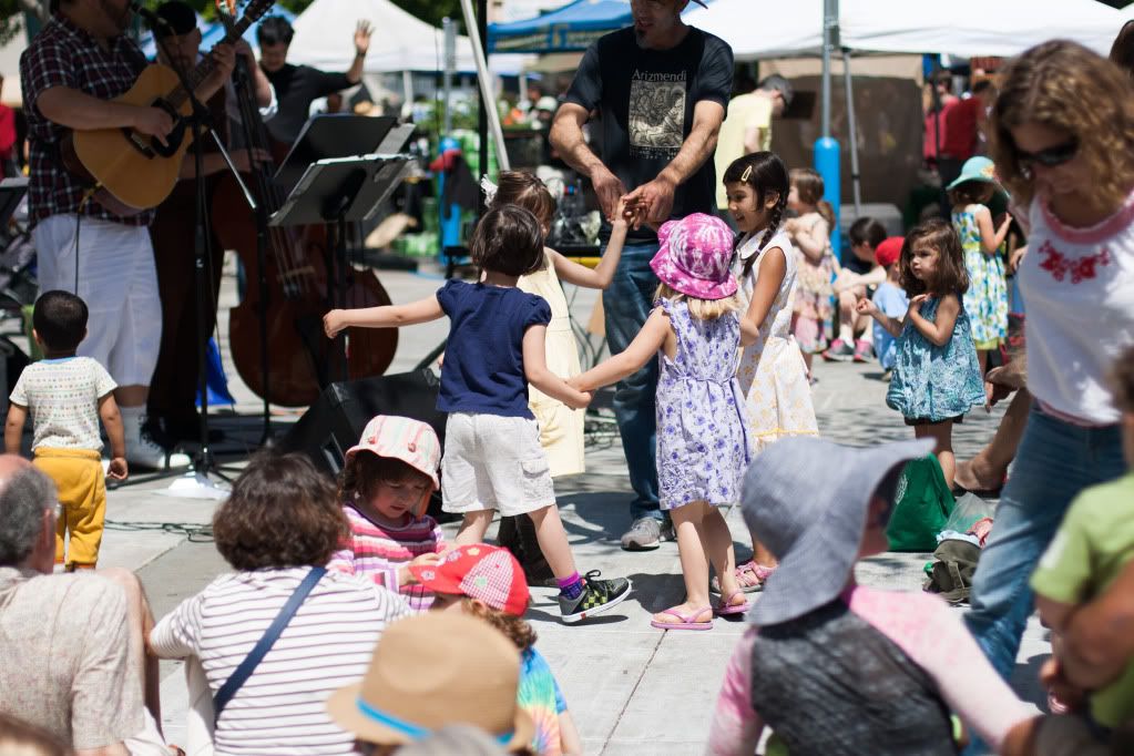 children dancing to music at the farmer's market