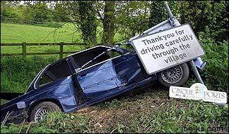 Car crashed into sign reading "Thankyou for driving carefully through the village"